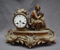 A 19th century ormolu mantle clock, depicting a seated maiden playing a lyre,