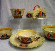 A Clarice Cliff crocus pattern cheese dish together with a similarly decorated plate and four bowls,