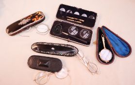A white metal mounted tortoiseshell glasses of oval form,