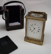 A brass cased carriage clock, with a platform balance the enamel dial with Roman numerals,