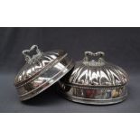 A graduated pair of old Sheffield plate domed meat dish covers,