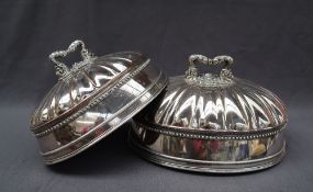 A graduated pair of old Sheffield plate domed meat dish covers,