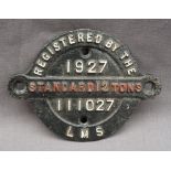 A railway wagon plate for LMS 111027, 1927, Standard 12 tons, of circular form with central strap,