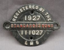 A railway wagon plate for LMS 111027, 1927, Standard 12 tons, of circular form with central strap,