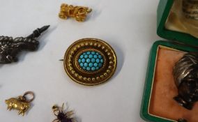 A Victorian yellow metal mourning brooch, set with a cluster of turquoise and bead decoration,