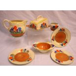 A Clarice Cliff Crocus pattern cheese dish and cover together with a similar jug,