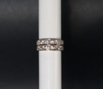 A diamond half eternity ring set with fourteen round old cut diamonds in two lines side by side,