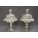 A pair of 19th century glass vases and covers with faceted knops and engraved body with a hipped