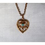 A turquoise and seed pearl pendant of heart shape to a 9ct gold setting and chain approximately 5