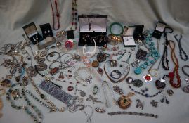 Assorted silver jewellery including necklaces, brooches, rings, mounted coins, Swatch watches,