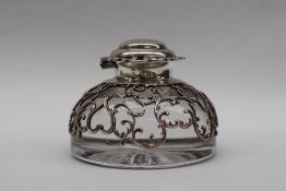 A late Victorian silver topped and glass inkwell, with a pierced domed cover,