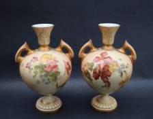 A pair of Royal Worcester porcelain twin handled vases transfer and infill decorated with flowers