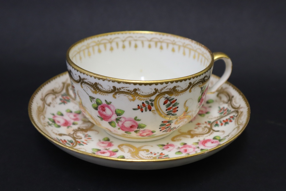 A Swansea porcelain tea cup and saucer painted with roses in a gilt garland border, 9. - Image 2 of 6