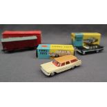 A Corgi Toys 219 Plymouth Sports Suburban Station Wagon with a brown roof,