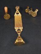 A gilt metal fob seal on a strap and clip together with a desk seal with banded agate handle and