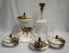 A set of four Shelley dressing table pots with lids decorated in the Balloons and Flashes pattern