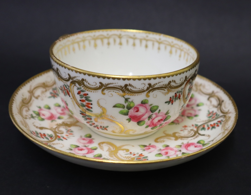 A Swansea porcelain tea cup and saucer painted with roses in a gilt garland border, 9. - Image 3 of 6