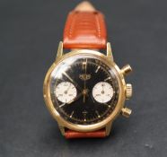 A gentleman's gilt metal Heuer chronograph wristwatch with a black dial with gilt baton markers and