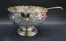 An Elizabeth II silver punch bowl with a scrolling rim, and leaf cast body on a spreading foot,