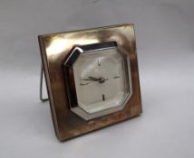An Elizabeth II silver desk clock of square form, the octagonal dial with batons, Marked RJC,
