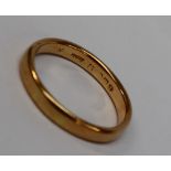 A yellow gold wedding band, hallmarks rubbed, size R 1/2,