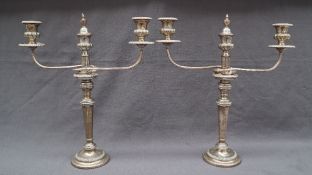 A pair of Sheffield plate twin branch candelabra with a central candle holder with vase flame