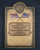 A gilt metal plaque enamelled with the Union Flag and the American flag on crossing poles for the