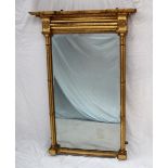 A 19th century gilt wall mirror, with an inverted breakfront moulded cornice with ball decoration,