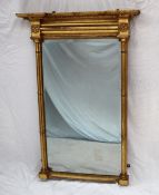 A 19th century gilt wall mirror, with an inverted breakfront moulded cornice with ball decoration,