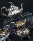 A Victorian silver four piece tea set, with a scrolling floral moulded body,