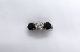 A three stone ring set with a central old cut diamond,