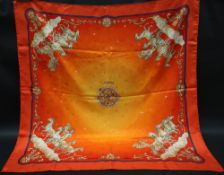 Hermes, a silk scarf in the "Cosmos" pattern with an orange background,