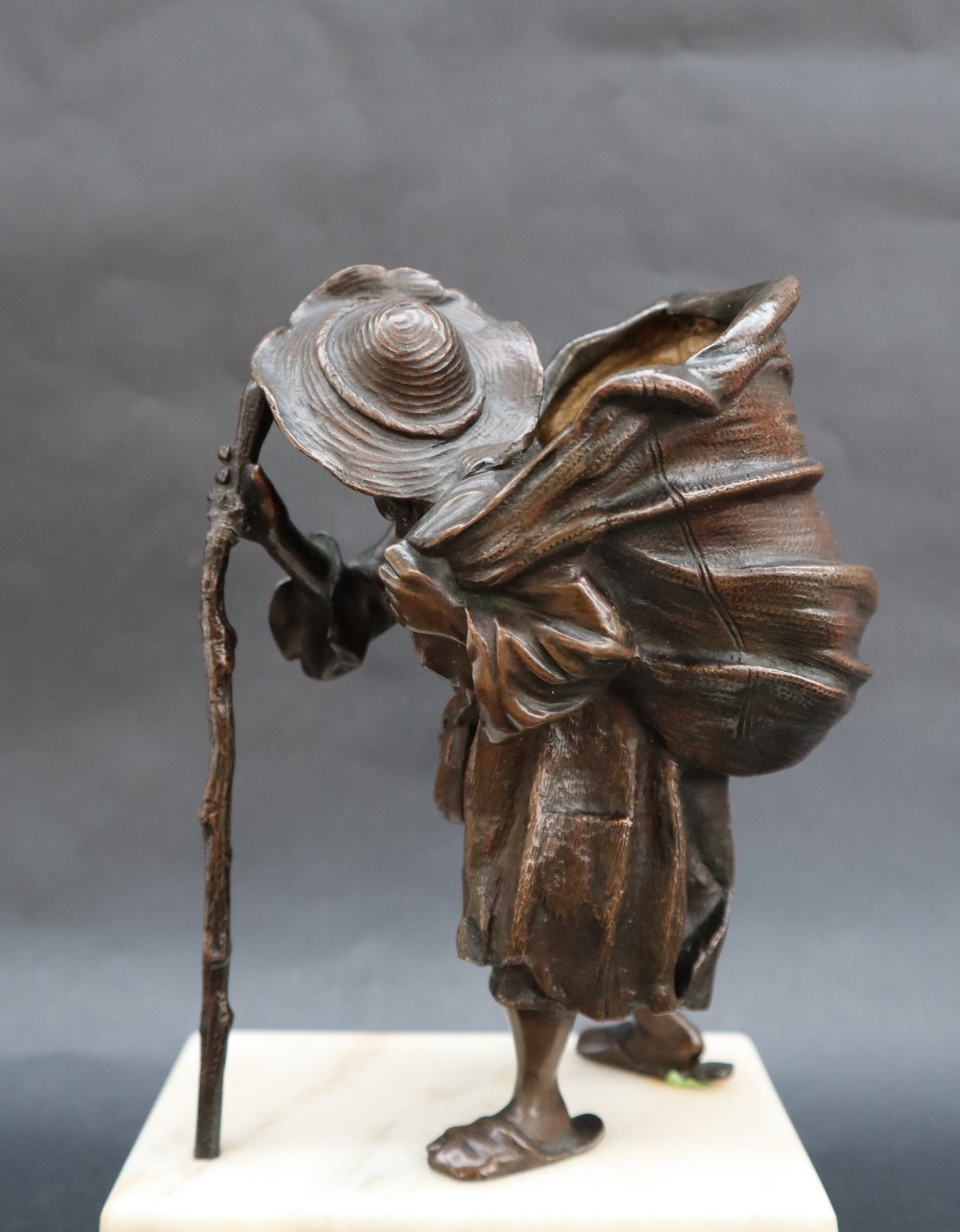 A bronze model of an elderly man with an open sack on his back, - Image 5 of 7