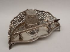 An Edward VII silver desk standish, of curved shape with a pierced border,