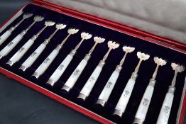 A set of twelve silver and mother of pearl cake forks with a CC crest, 13.