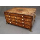 A 19th century mahogany jewellery cabinet with a hinged lid above two short and two long faux