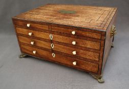 A 19th century mahogany jewellery cabinet with a hinged lid above two short and two long faux