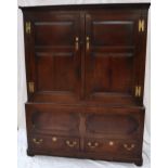 An 18th century oak side cabinet with a moulded cornice above a pair of four panelled doors,