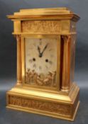 A gilt metal mantle clock of architectural form,