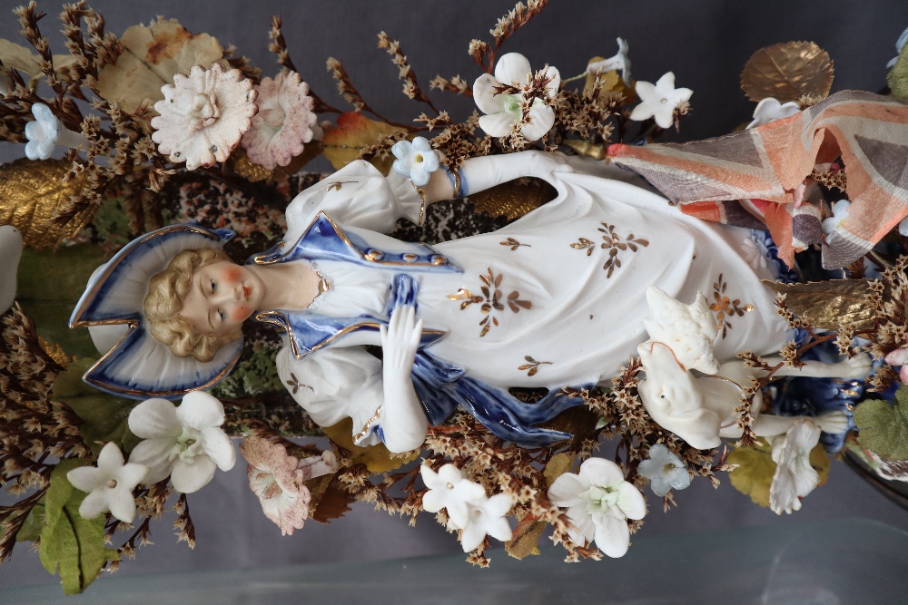 A pair of 19th century continental porcelain figures surrounded by porcelain flowers under glass - Image 3 of 7