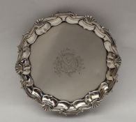 An 18th century silver waiter, with a shell and scrolling border,