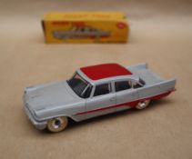 A Dinky Toys 192 De Soto Fireflite Sedan in grey with red roof and flash,