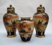 A garniture of three Noritake vases, including two lidded vases 27cm high and a twin handled vase,