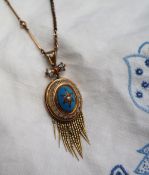 A Victorian gilt metal fringe pendant set with a central pearl and blue and white enamel on a