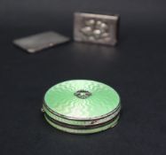 A silver and green enamel decorated patch box of circular form,