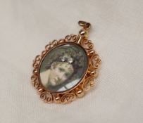 A gilt metal portrait miniature double sided pendant, printed with portrait heads, approximately 5.