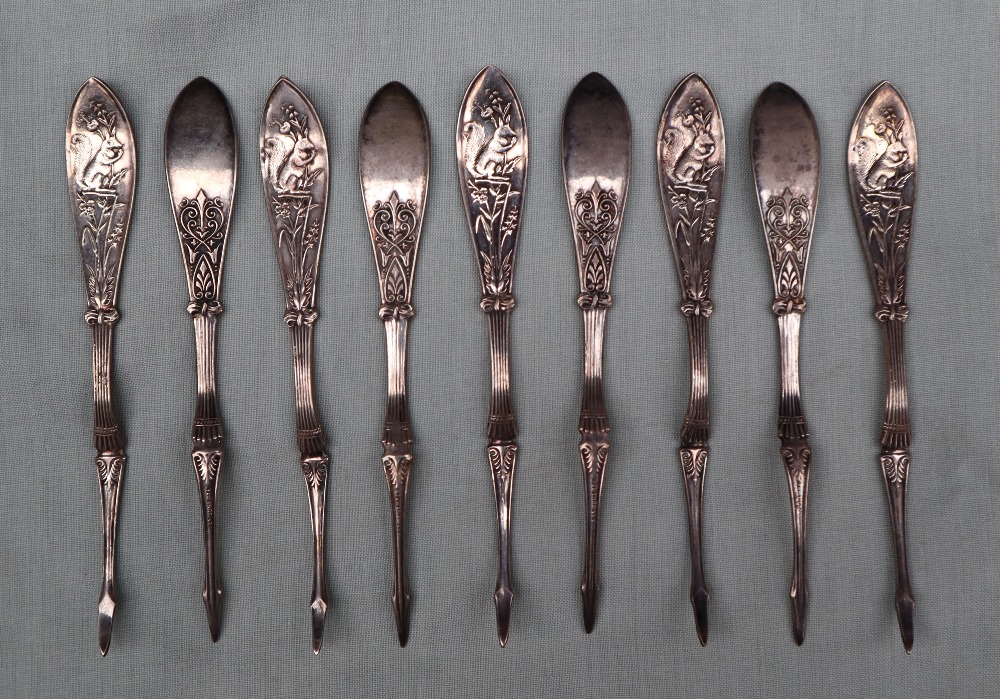 A set of nine Victorian nut picks with squirrel decorated handles