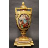 A Vienna style porcelain twin handled vase, the domed top with a flame finial,