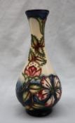 A Moorcroft pottery "Sweet Briar" pattern slender single stem vase with a yellow ground,