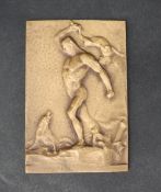 A bronze medallion depicting a Herculean figure fighting wolves, initialled EV 1907,